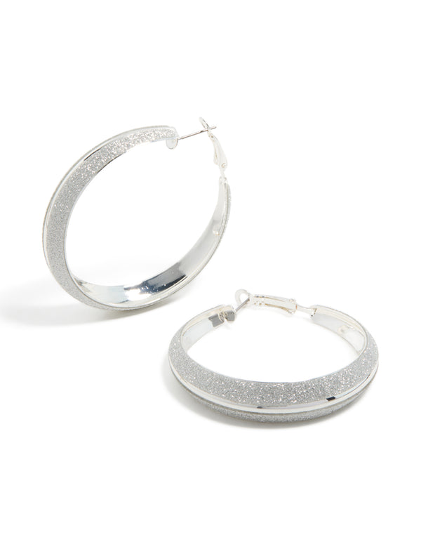 Showcasing silver glitter hoop earrings front view
