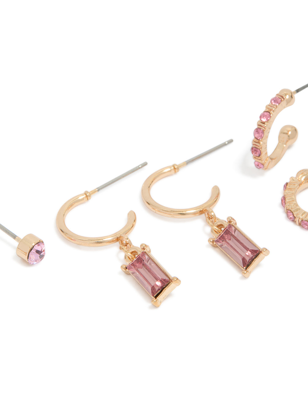 Showcasing gold hoop and stud earrings in a 3-pack with light pink diamante details close up view