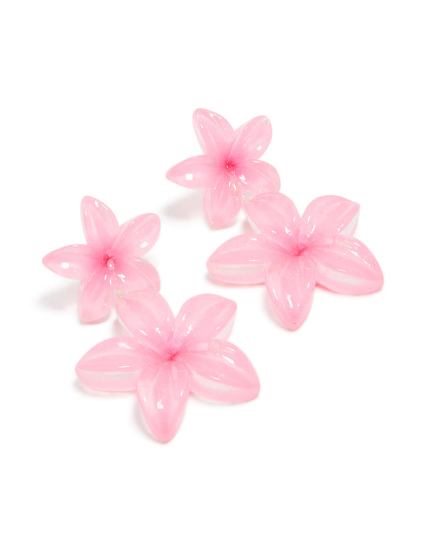 Showcasing statement drop earrings with acrylic frangipani flowers in a pink color front view