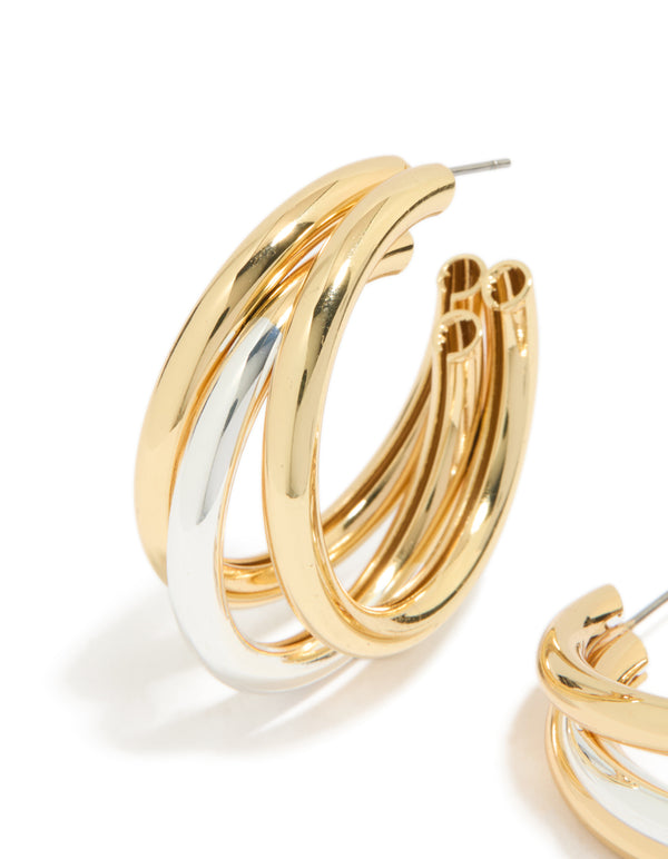Featuring statement large illusion hoop earrings with gold and silver plated finish close up view