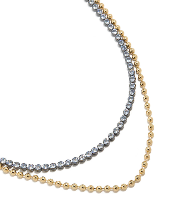 Showcasing a mixed metal plated cubic zirconia double layered tennis ball chain necklace with delicate gold detailing close up view