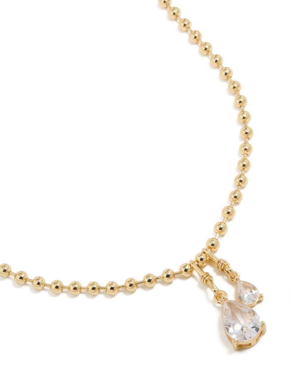 Showcasing a gold plated double cubic zirconia teardrop pendant necklace with ball chain close up view