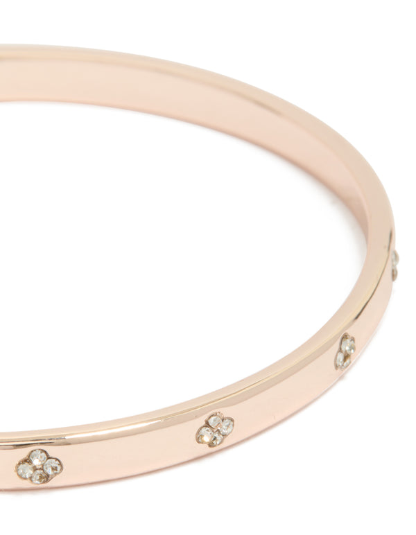 Featuring a rose gold plated diamante flowers bangle close up view