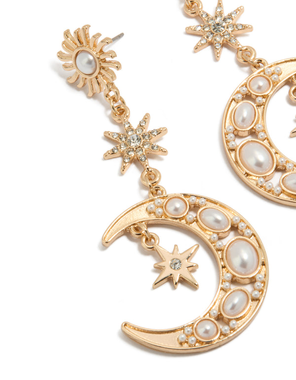 Crafted with gold and pearl is this celestial drop earrings close up view