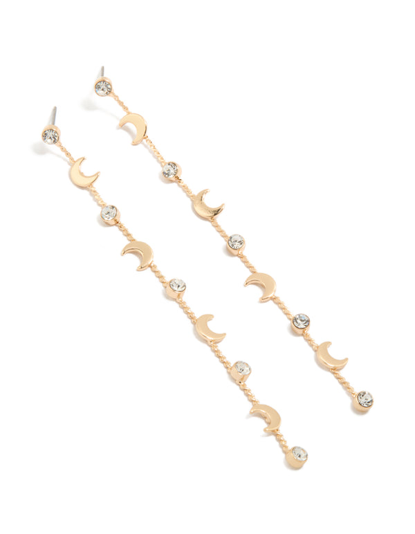 Showcasing gold clear diamante and celestial thin drop earrings with charm accents front view