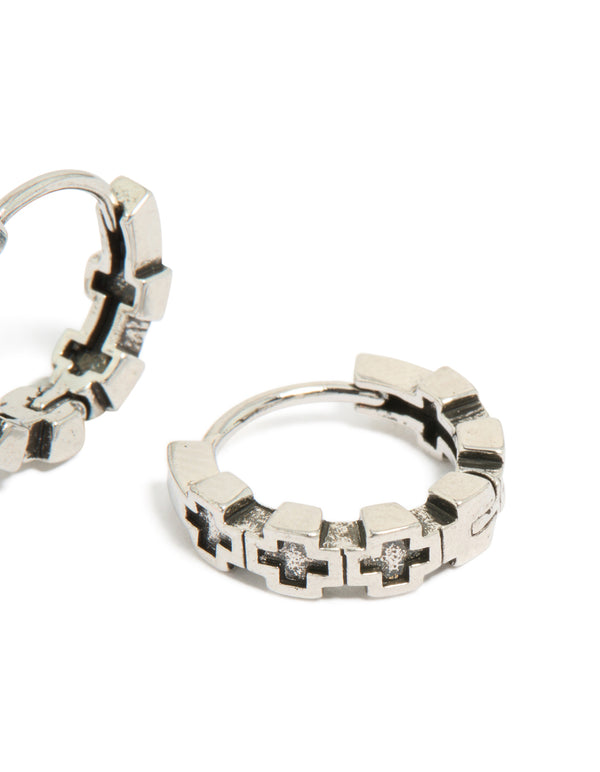 Designed with waterproof brushed stainless steel and multi cross detailing, these mens huggie hoop earrings in silver and black post detail view