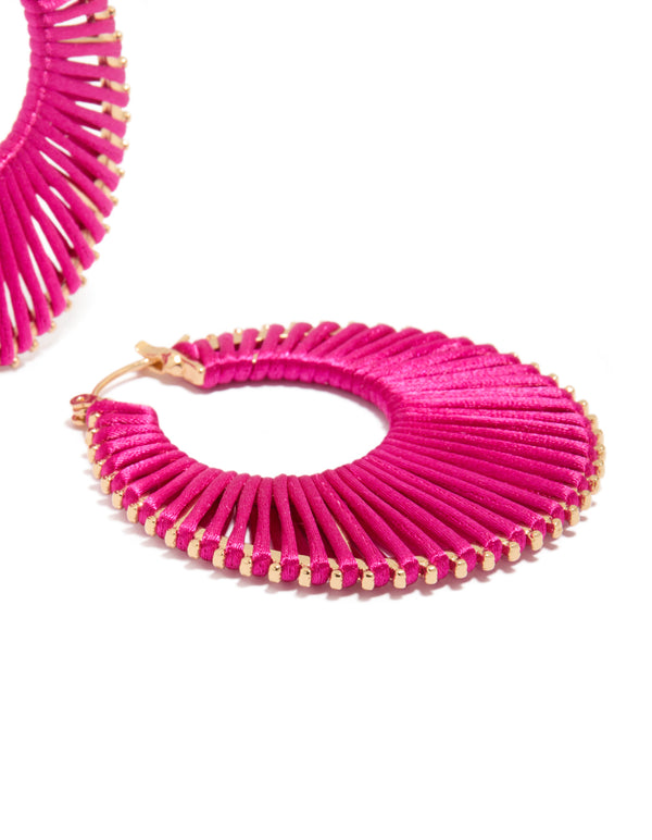 Highlighting hot pink threaded hoop earrings with statement design and gold finishing post detail view