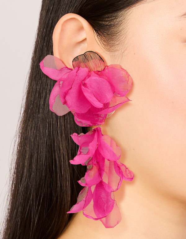 Featuring hot pink fabric flower drop earrings with statement design on ear view