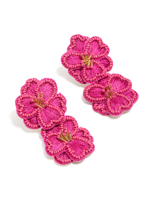 Featuring hot pink fabric beaded double flower drop earrings with statement design and gold accents front view