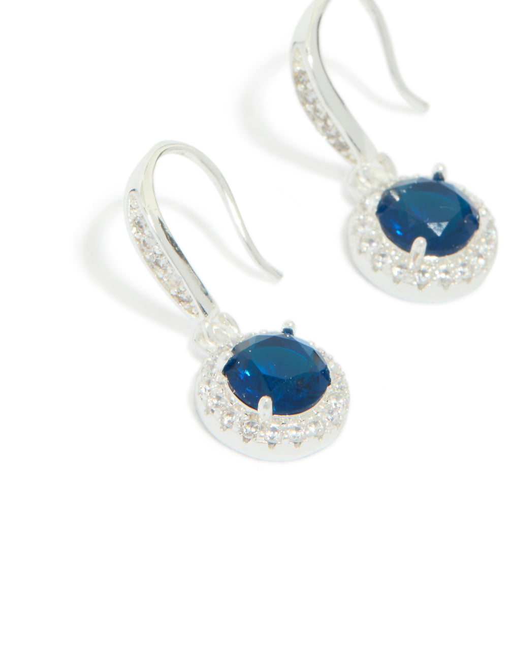 Highlighting silver plated sapphire blue cubic zirconia halo drop earrings with navy stones close up view
