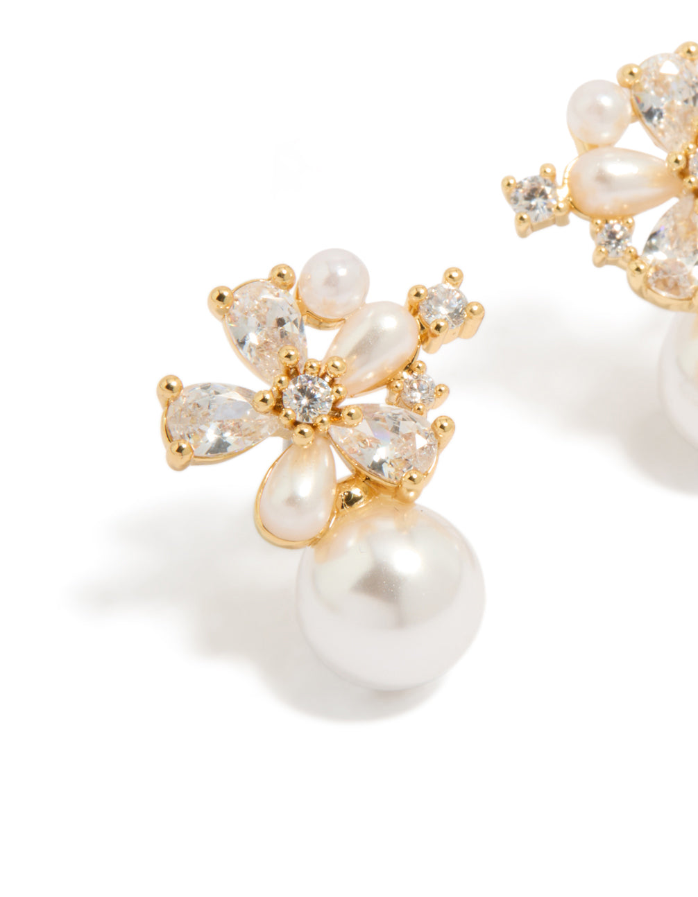 Highlighting the intricate floral design, these gold plated hoop earrings with cubic zirconia and pearl accents in ivory close up view
