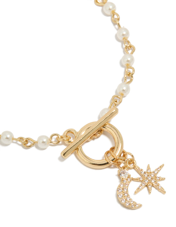 Beautifully crafted gold plated pearl and cubic zirconia bracelet with celestial star moon charm fob close up view