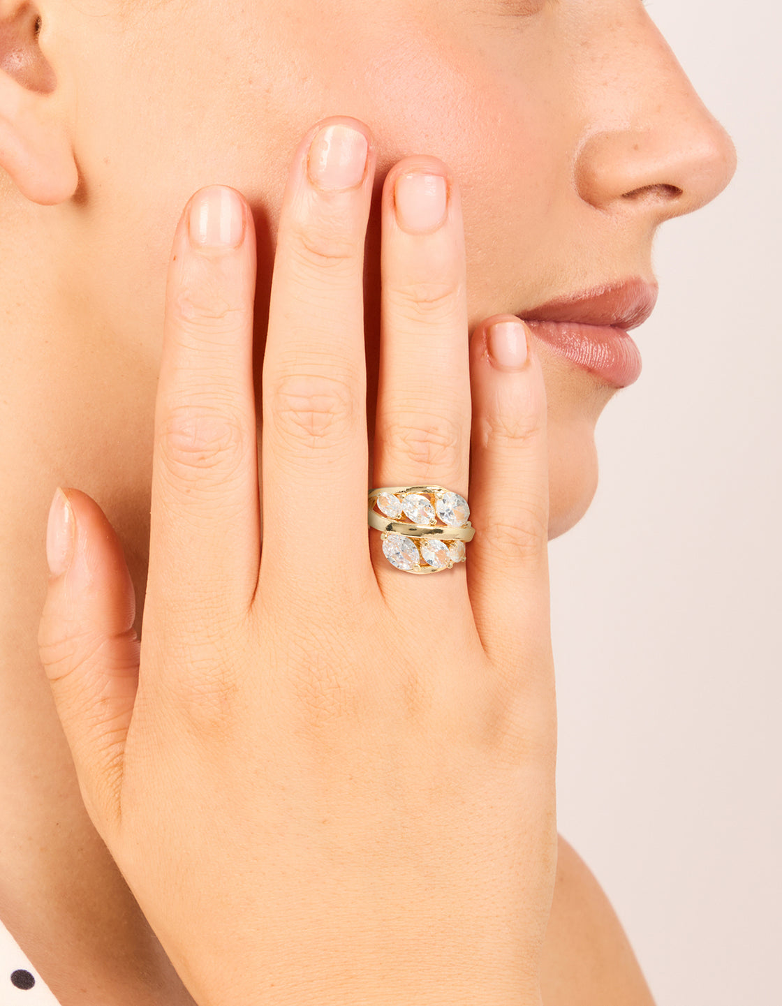 Highlighting a gold plated cubic zirconia oval clusters layered ring with statement style on finger view