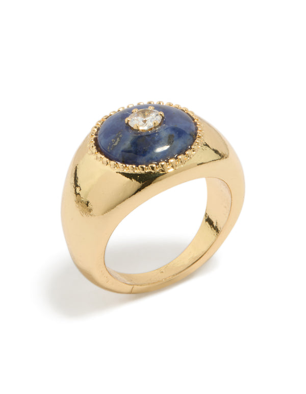 Featuring a gold plated chunky cubic zirconia blue stone ring with statement design side detail view