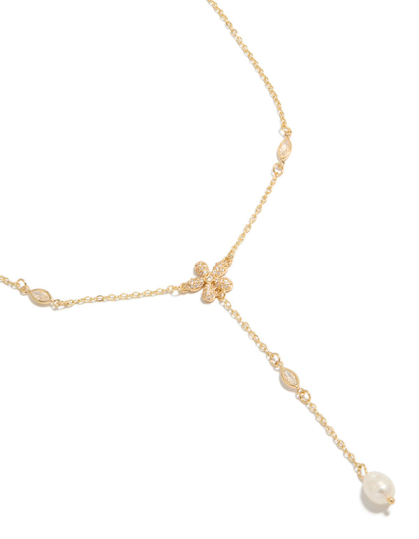 Showcasing a gold cubic zirconia freshwater pearl and flowers Y-necklace close up view