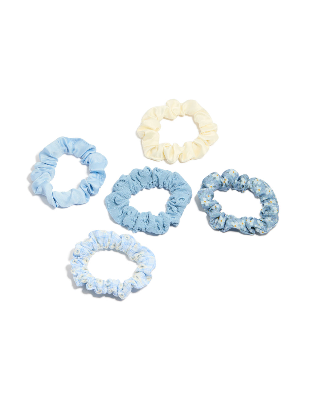Showcase featuring daisy flower and checkered fabric scrunchies in a 5-pack with light blue, ivory, white front view