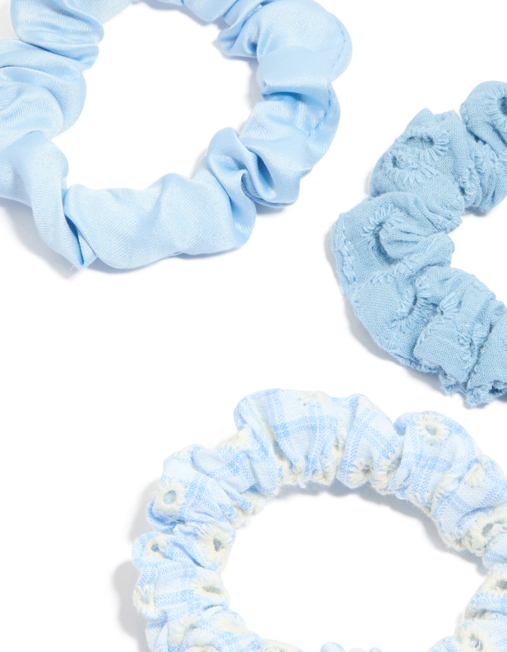 Featuring daisy flower and checkered fabric scrunchies in a 5-pack with light blue, ivory, white detail view