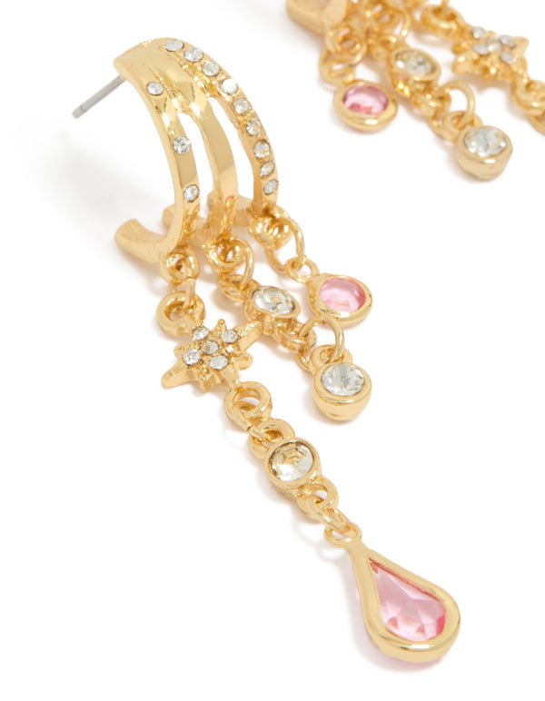 Highlighting chain drop earrings featuring star celestial charm details with gold plated cubic zirconia stones in pink and clear close up view