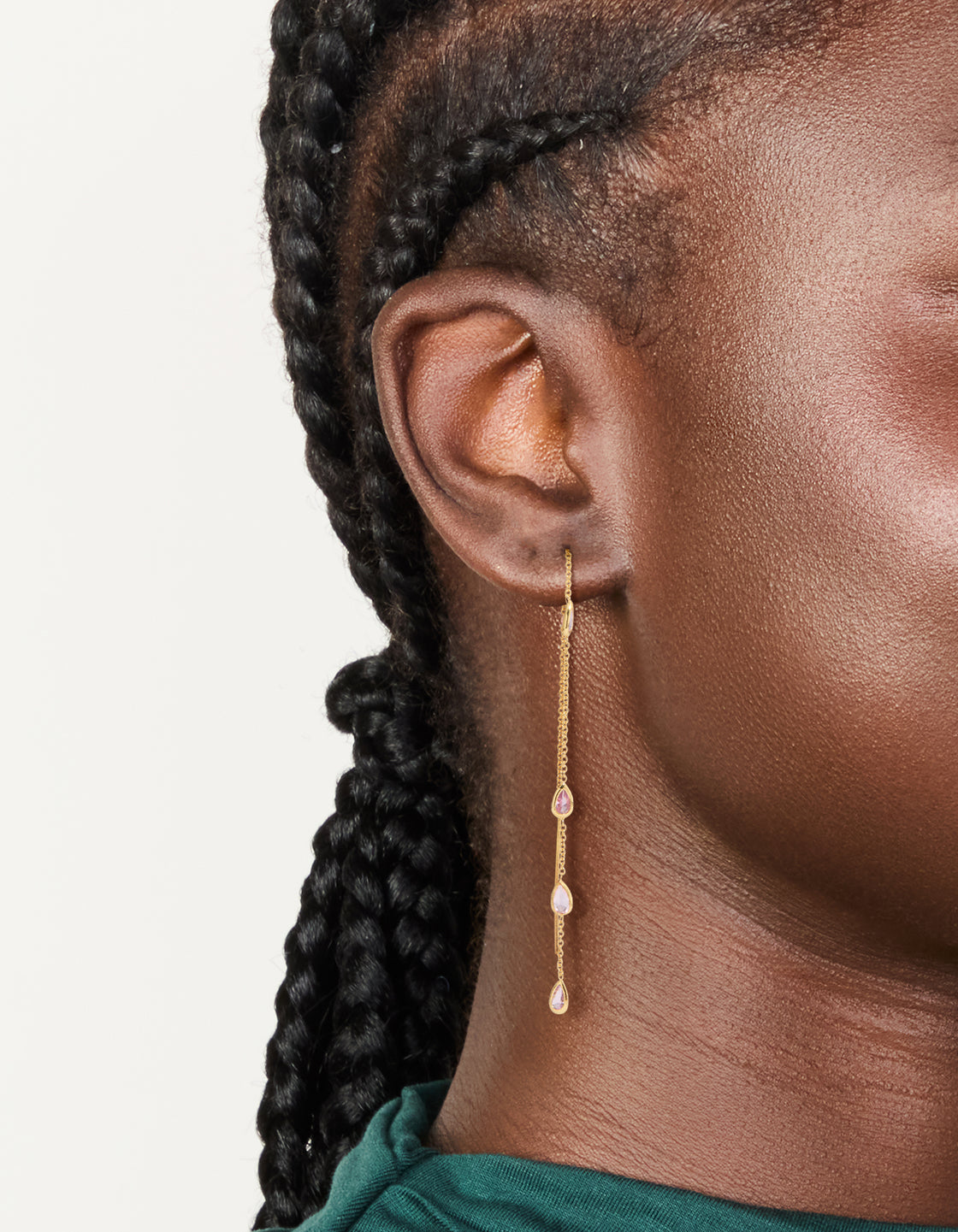 Featuring pear shape pink diamante stone station accents, these gold plated threader earrings are shown on ear view