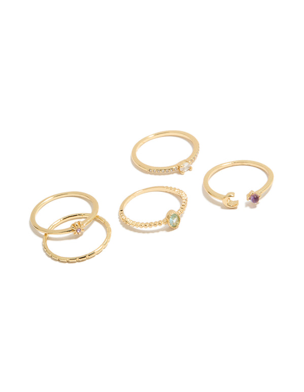 Showcasing a gold celestial cubic zirconia rings 5-pack featuring sun, moon and oval stone cut in a dainty style front view