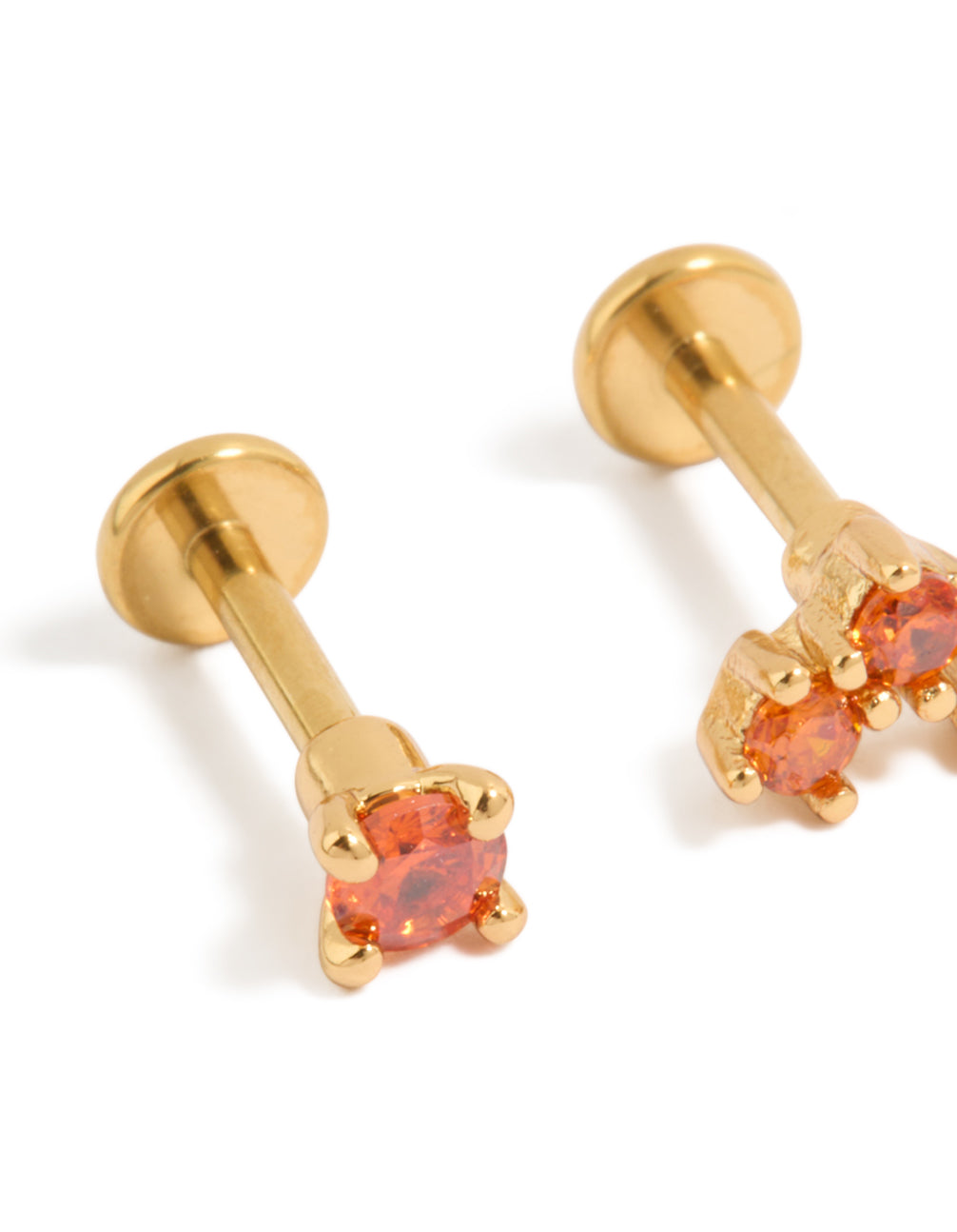 Designed with gold plated titanium red cubic zirconia flat back studs and red accents close up view