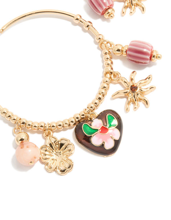 Crafted gold brown heart and sun charm hoop earrings featuring floral beads, celestial design and striped pattern in close up view