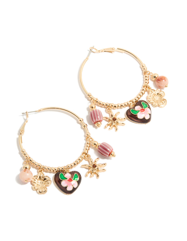 Showcasing gold brown heart and sun charm hoop earrings featuring floral beads, celestial design and striped pattern in front view