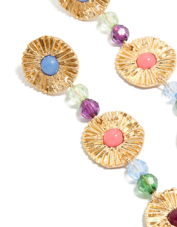 Elegant statement drop earrings with round discs and multicoloured beads in gold, light blue, pink, and red close up view