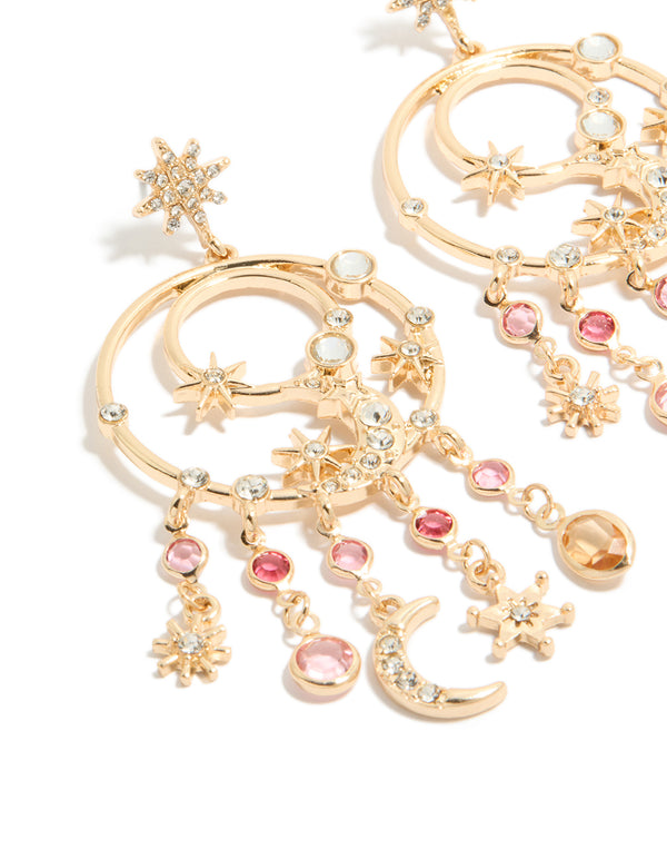 Crafted from gold with pink and clear diamantes celestial charm accents, these statement circle drop earrings display star motifs and stud closures in close up view
