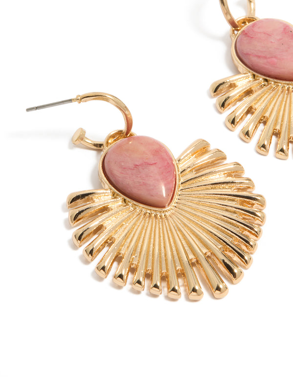 Crafted from gold with light pink stone, these fanned drop earrings feature statement style in close up view