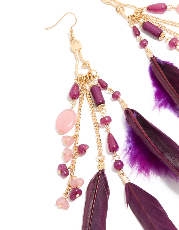 Featuring gold purple beaded and feather drop earrings with intricate detail close up view