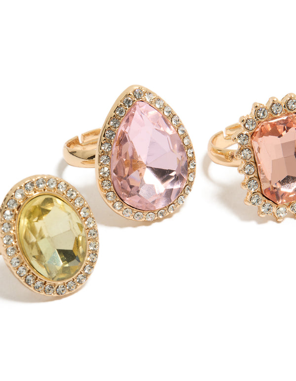 Designed with statement halo and oval stone cut diamante rings in pink and purple pastel tones close up view