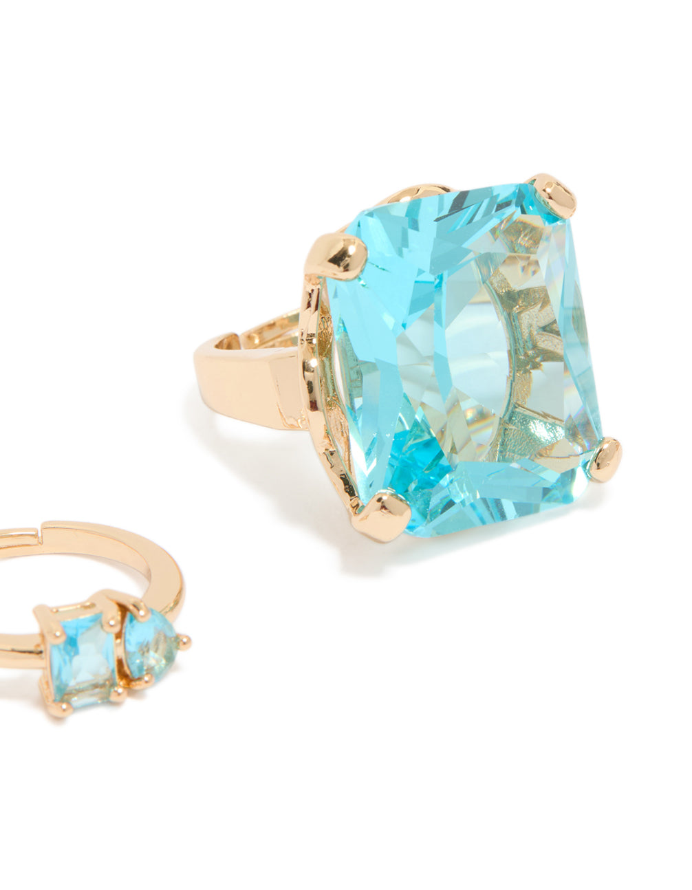 Designed with gold statement band and oversized oval cut aqua diamante close up view