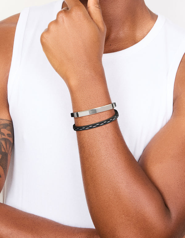 Featuring a bar bracelet with cord, PU leather, and stainless steel materials in waterproof black and silver on wrist view