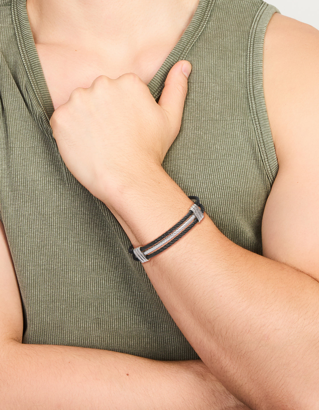 Featuring a mens waterproof stainless steel black and silver wire twisted wrist cuff bracelet on wrist view
