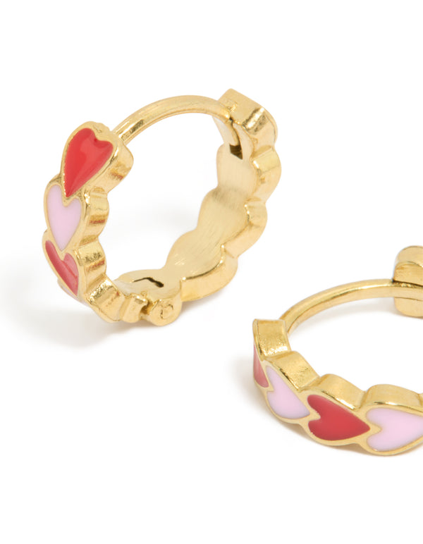 Featuring waterproof heart huggie earrings made from gold plated stainless steel with red and pink enamel in Huggie closure close up view