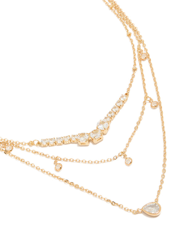 Showcasing a gold plated cubic zirconia tennis and pendant layered necklace with charm featuring dainty styling close up view