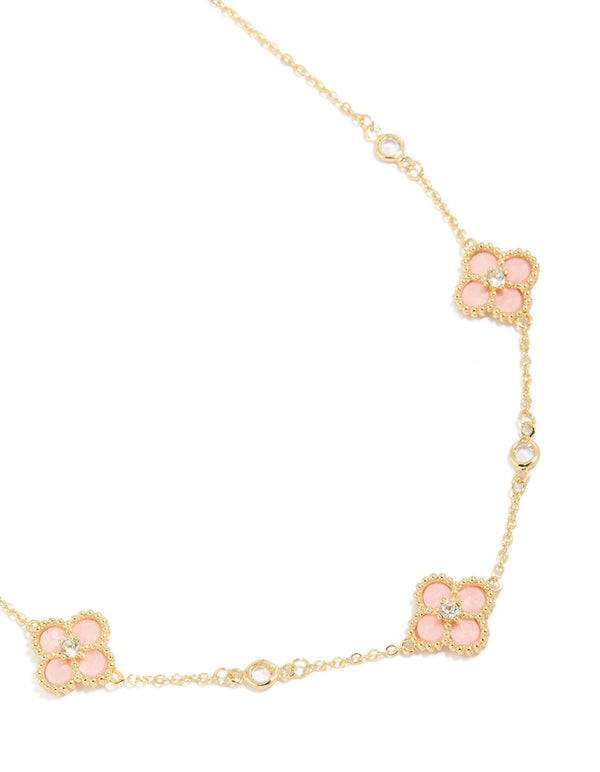 Beautifully crafted gold plated pink cubic zirconia flower trio necklace in a statement style close up view