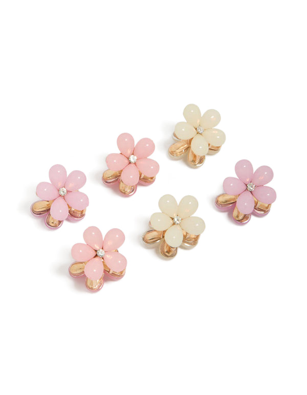 Discover these mini claw clips featuring floral resin design in light pink and beige with gold accents front view