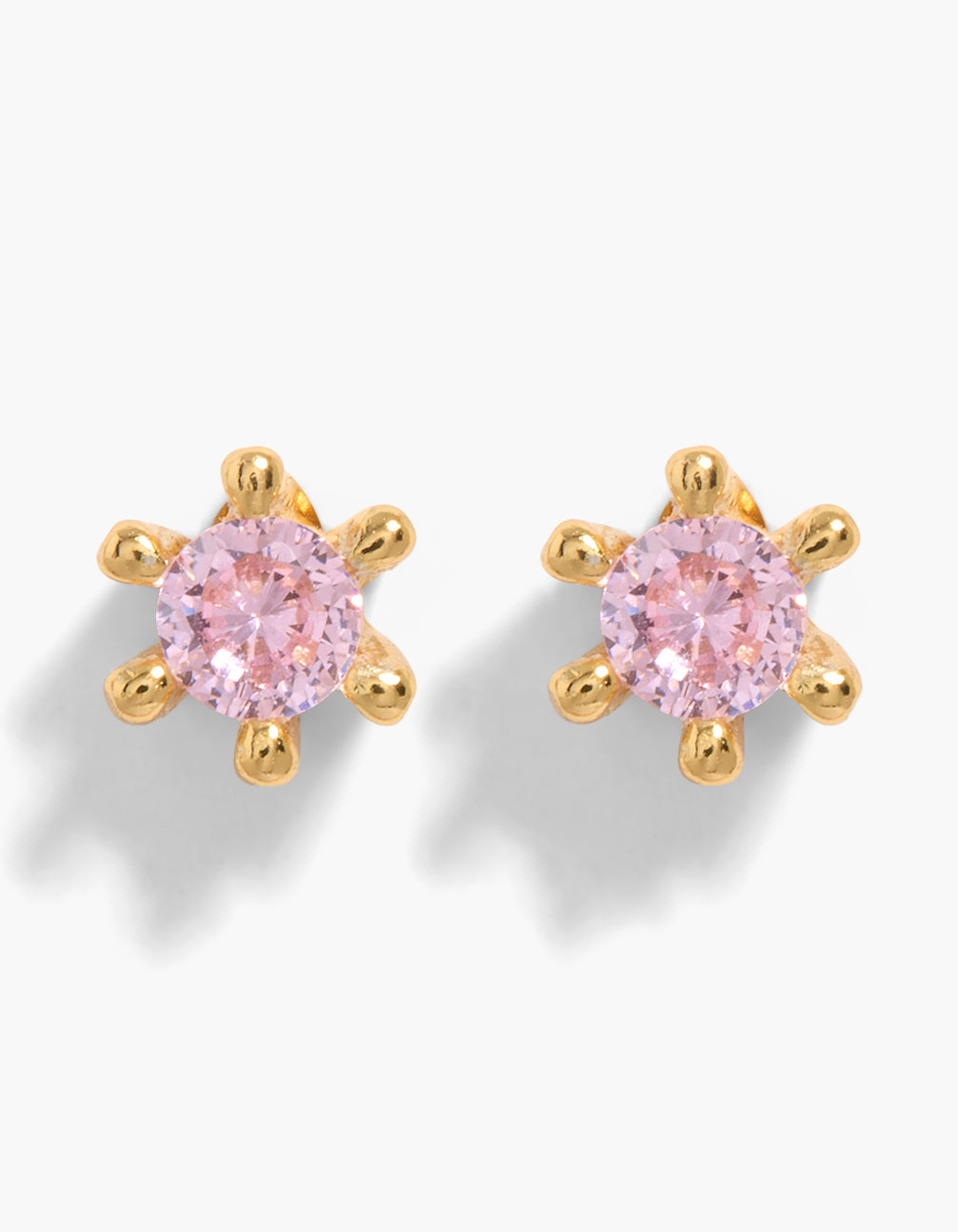 Elegant gold plated sterling silver stud earrings featuring pink cubic zirconia in dainty 6 claw setting front view