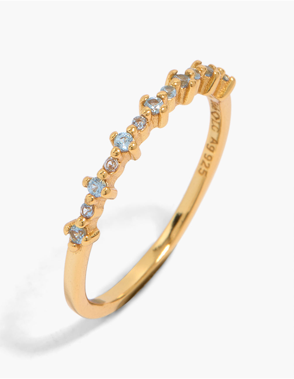 Showcasing a gold plated sterling silver band ring featuring cubic zirconia in light blue front view