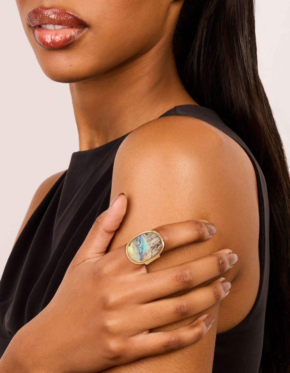 Featuring a gold vintage oval statement ring with ocean accents and pale turquoise tan purple tones on finger view
