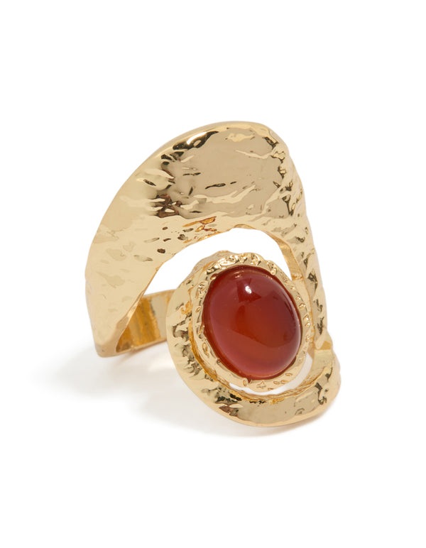 Introducing a statement gold plated molten large stone ring featuring a dark orange cabochon in textured metal front view
