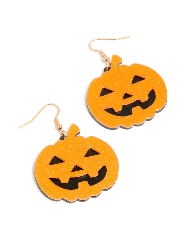 Showcasing statement drop earrings with glitter charm pumpkins in orange, black, and gold front view
