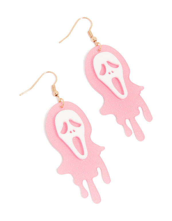 Discover statement drop earrings featuring pink acrylic melting ghost face with glitter accents in white and goldenrod tones front view