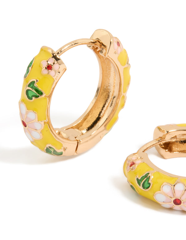 Designed with huggie earrings featuring floral yellow enamel, pink flower and leaf prints in statement gold close up view