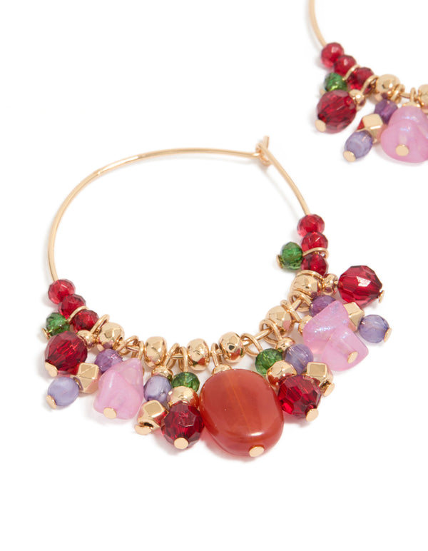 Designed with thin hoop closure adorned with colorful beaded charms in red, pink, green, and gold close up view