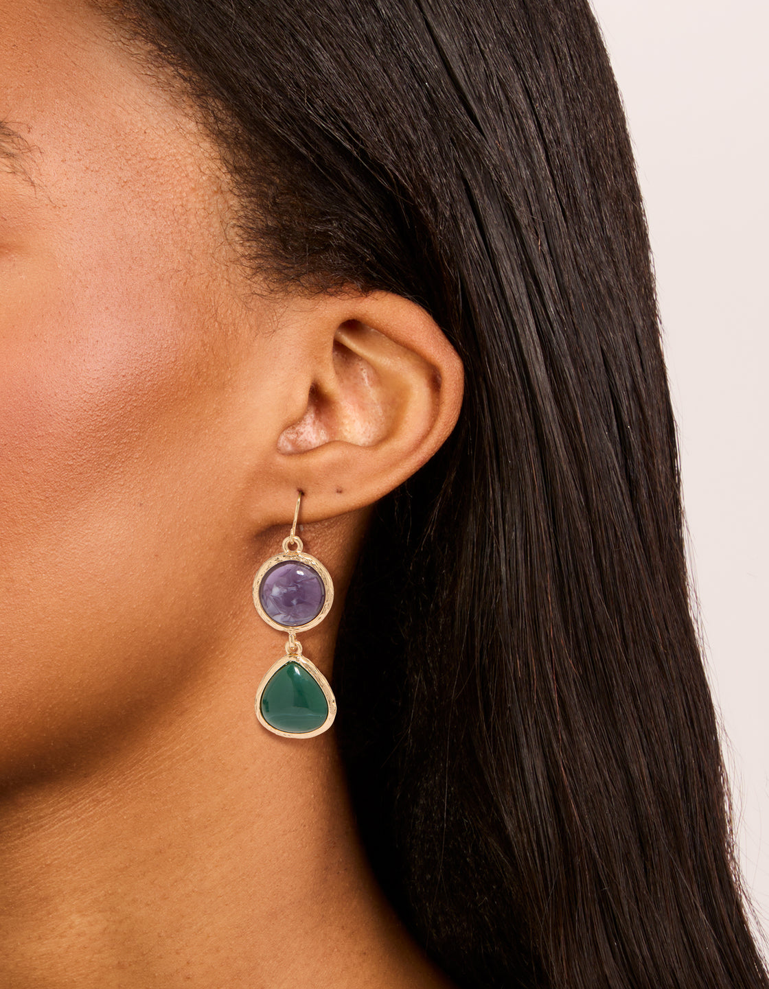 Showcasing gold purple and green acrylic drop earrings with statement style on ear view