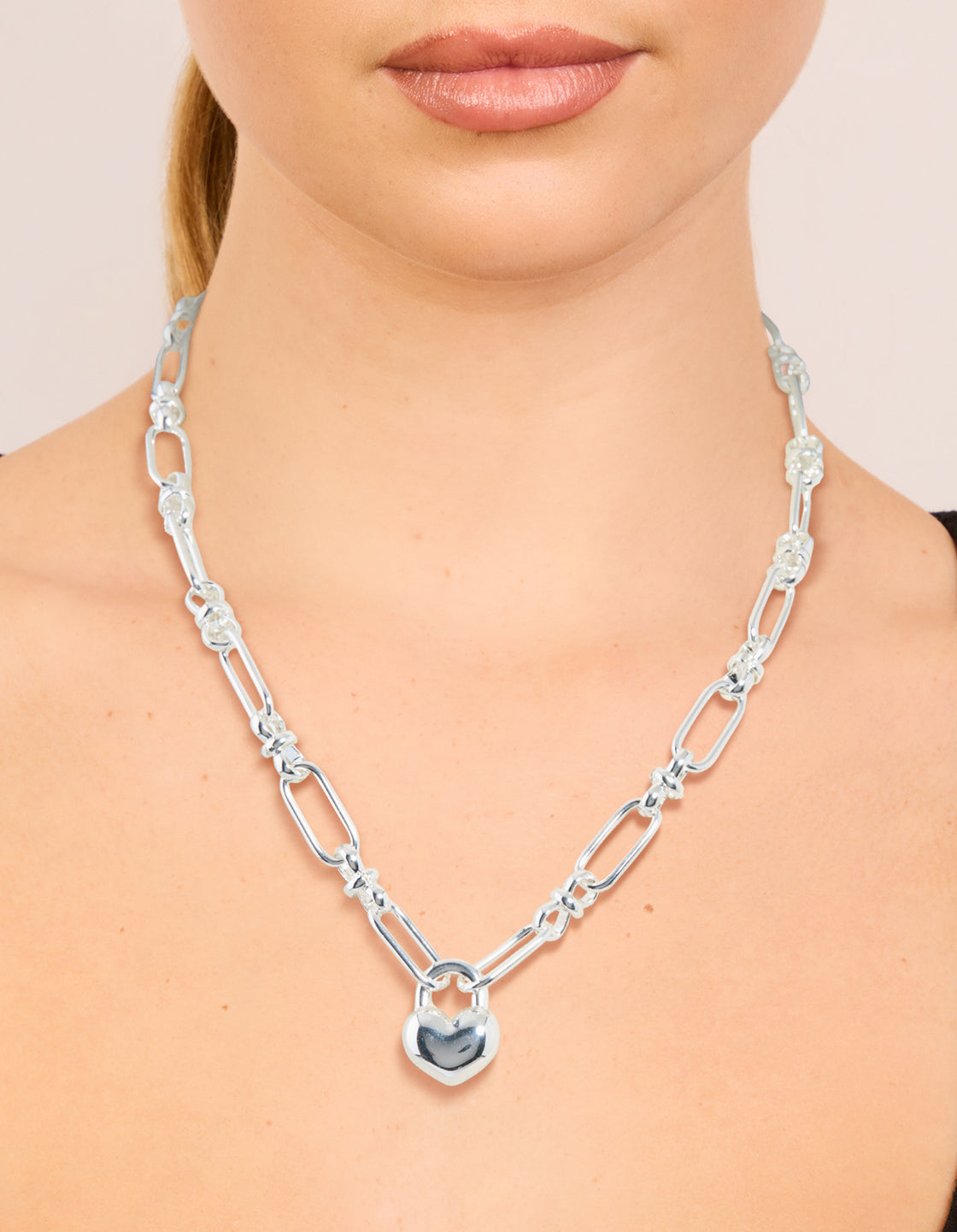 Featuring a waterproof stainless steel bubble heart chunky necklace in silver on neck view