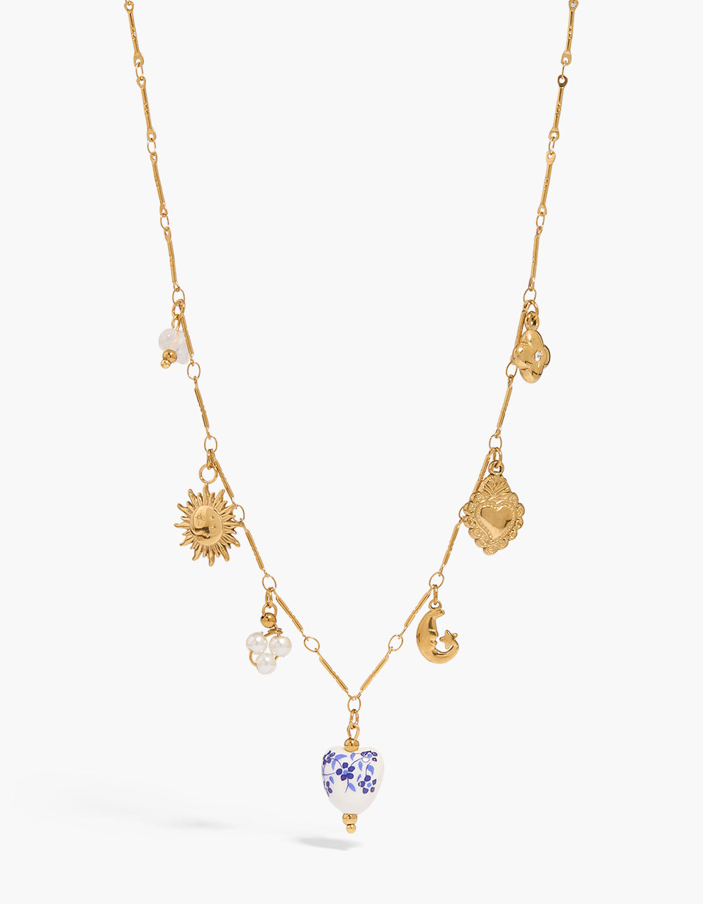 Showcasing a waterproof stainless steel necklace with painted floral, heart, celestial charms featuring sun, moon, star, beads and cubic zirconia in gold plated finish close up view